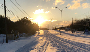 Snow covered street with car tracks
